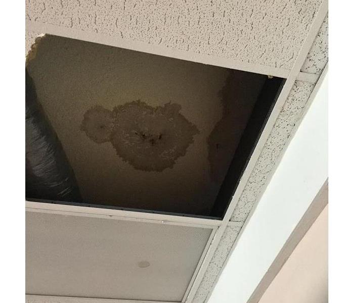 Ceiling damage from storm rain.