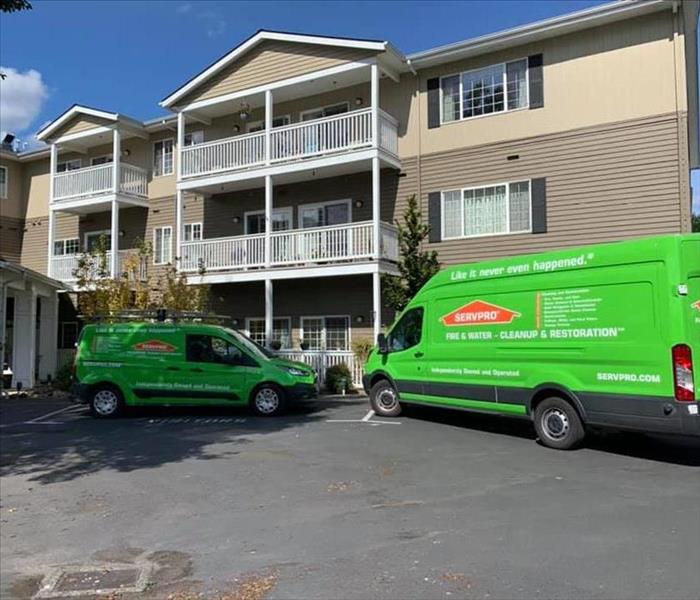 SERVPRO vehicles parked in front of senior living facility.