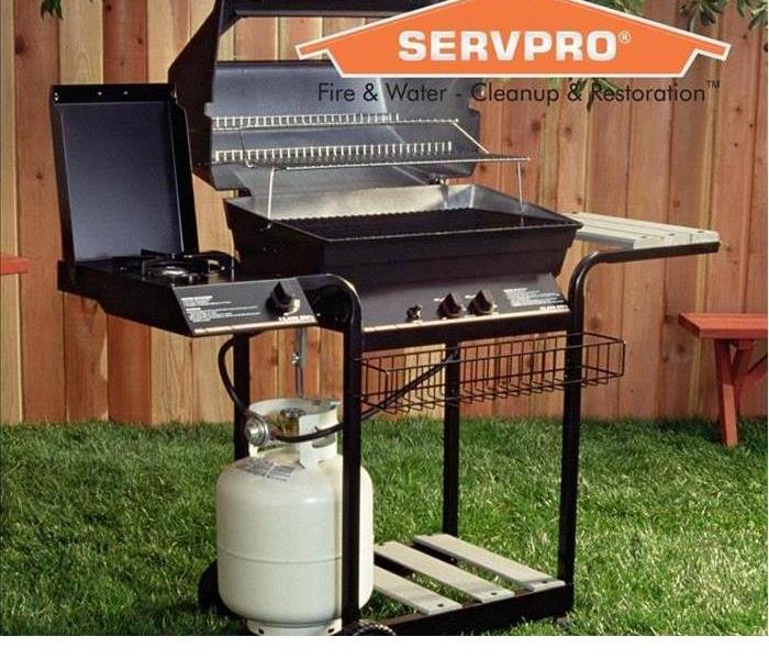 BBQ in grass with SERVPRO log